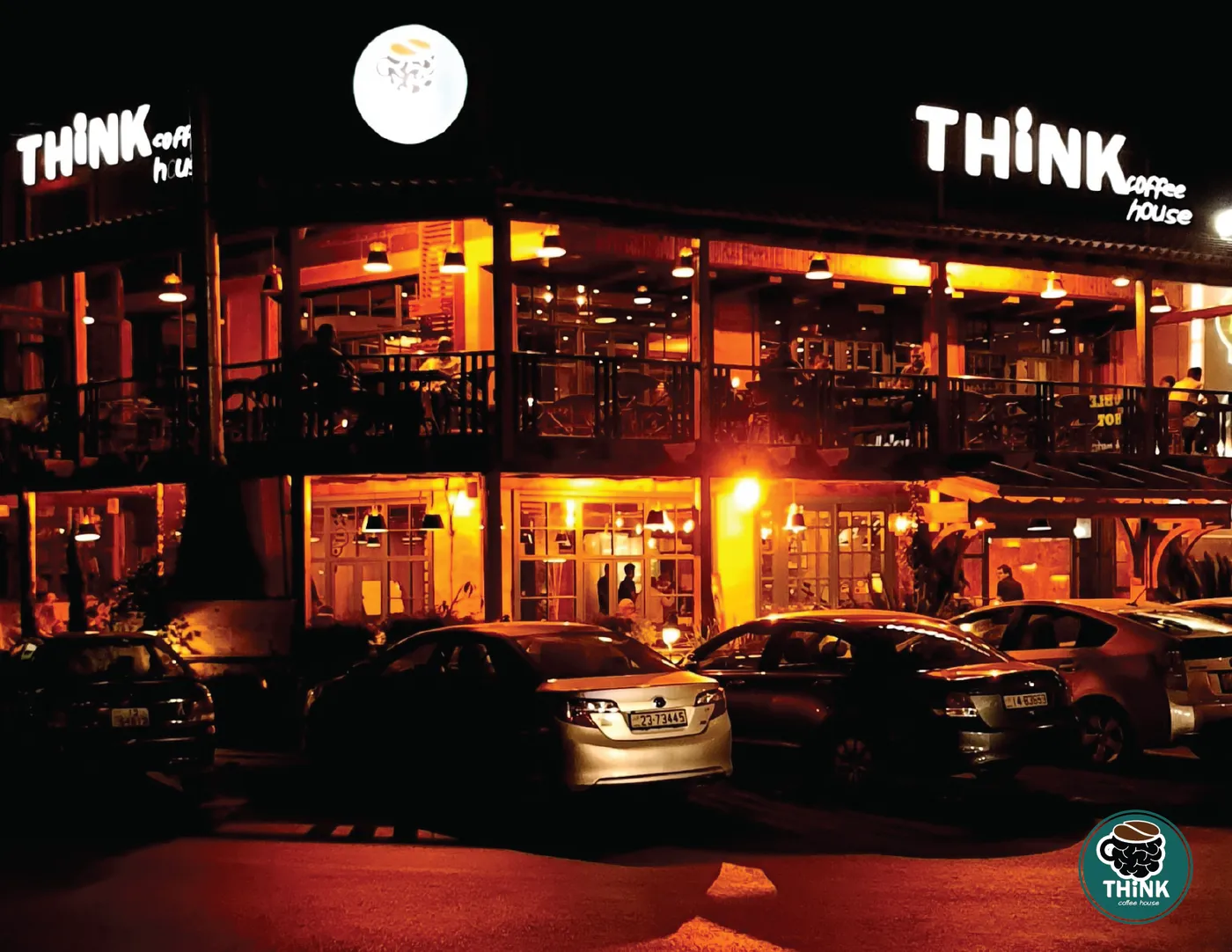 Think Coffee House lit up at night, seen from the street